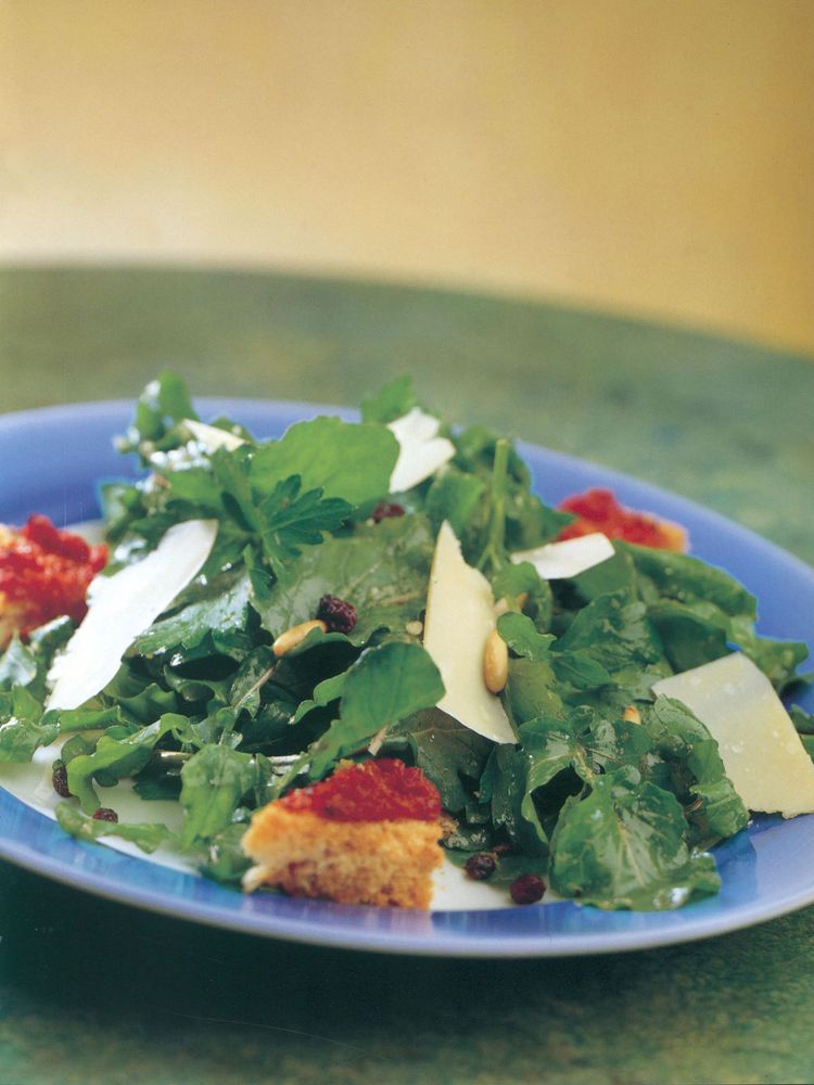 Rocket and flat-leaf parsley salad with currants, parmesan, a balsamic dressing and tomato crostini from The Café Paradiso Cookbook by Denis Cotter