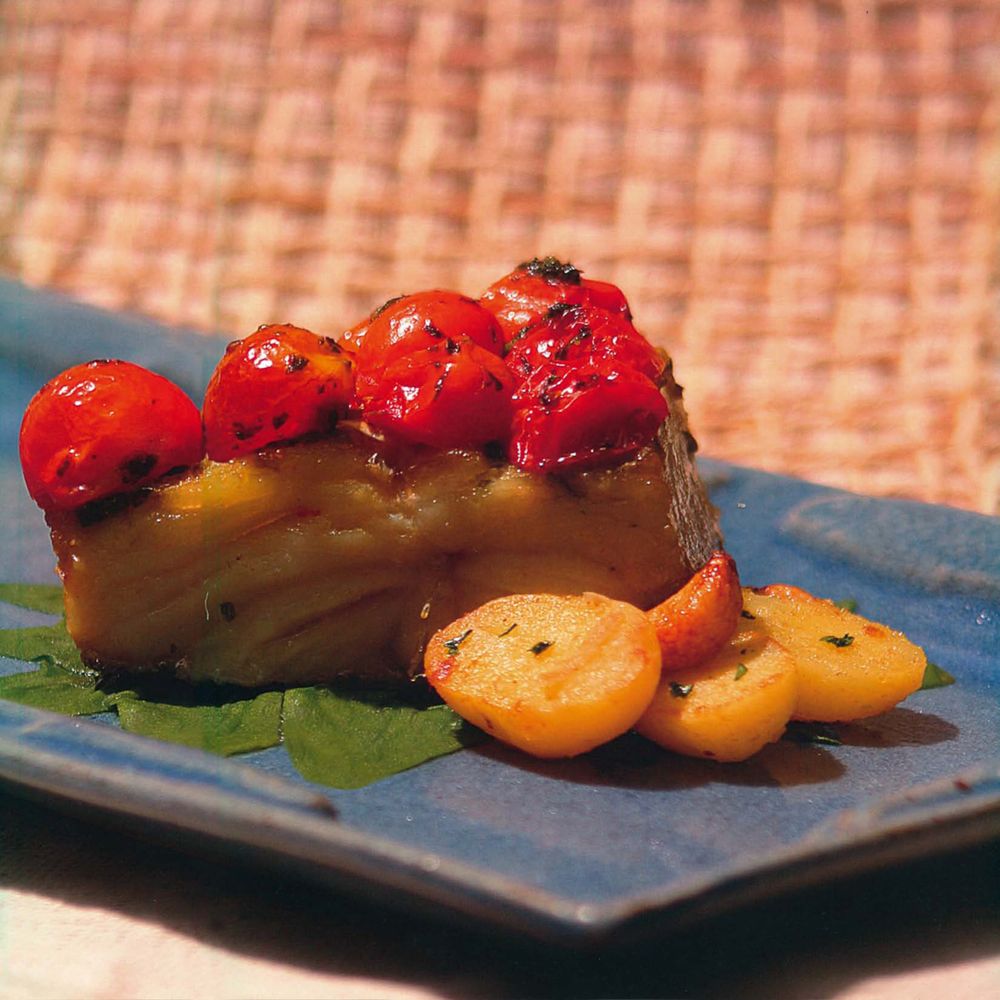 Roasted cod chunks with tomato confit, sautéed spinach and golden potatoes from Brazil Rhythms and Recipes by Morena Leite