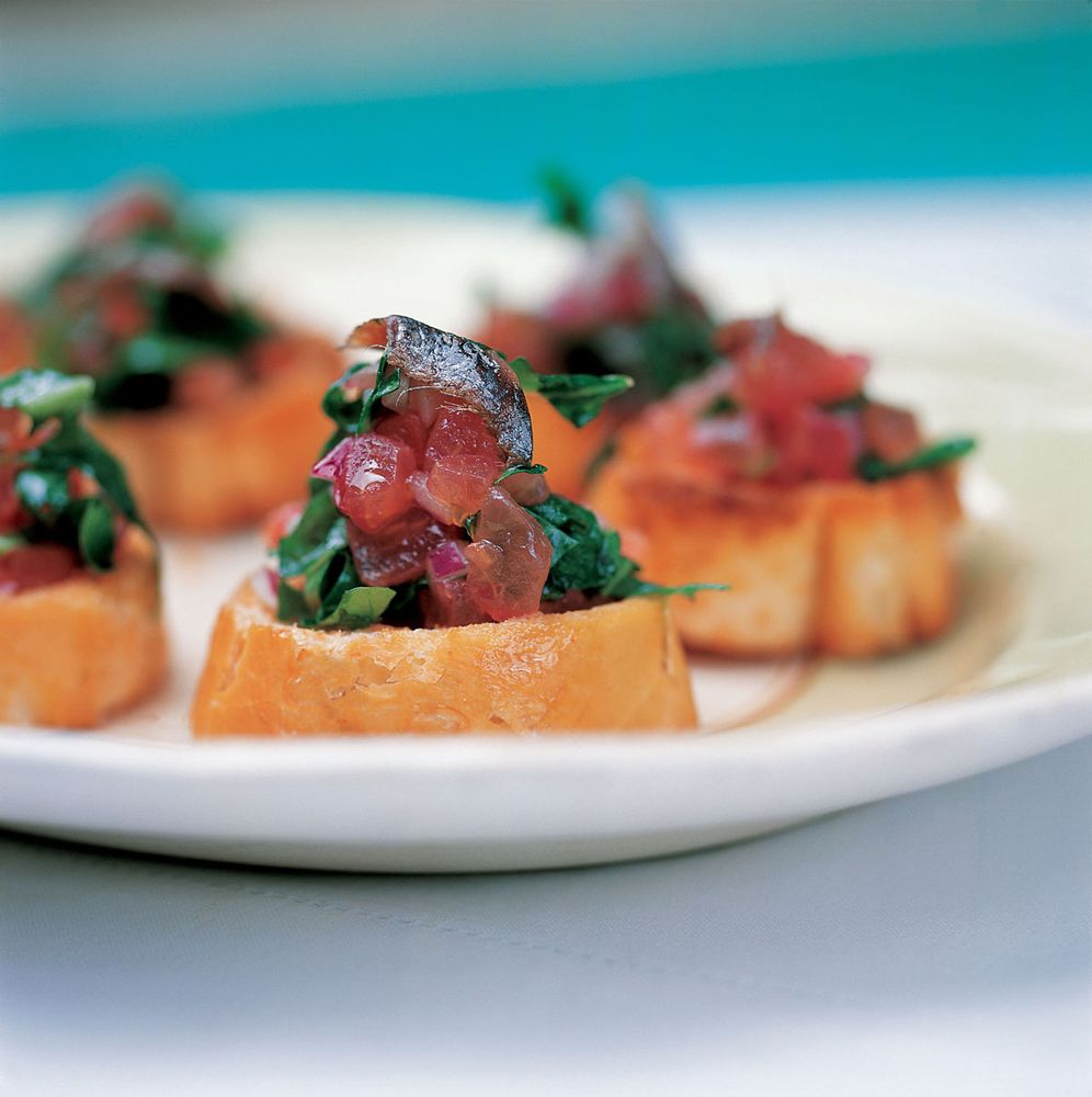 Crispy Baguette Rounds with Rocket, Red Onion, Tomato and Anchovy from
