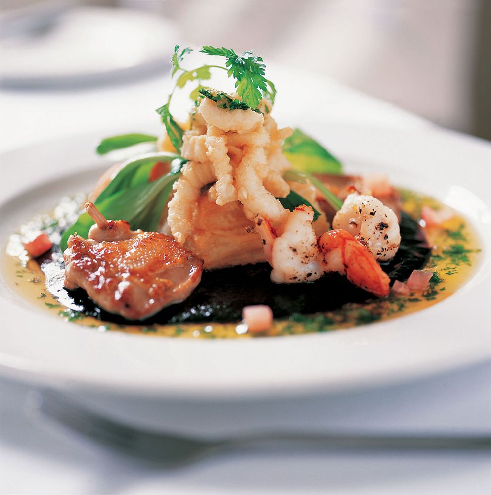 Tender quail suprême, calamari and tiger prawns on puff pastry with