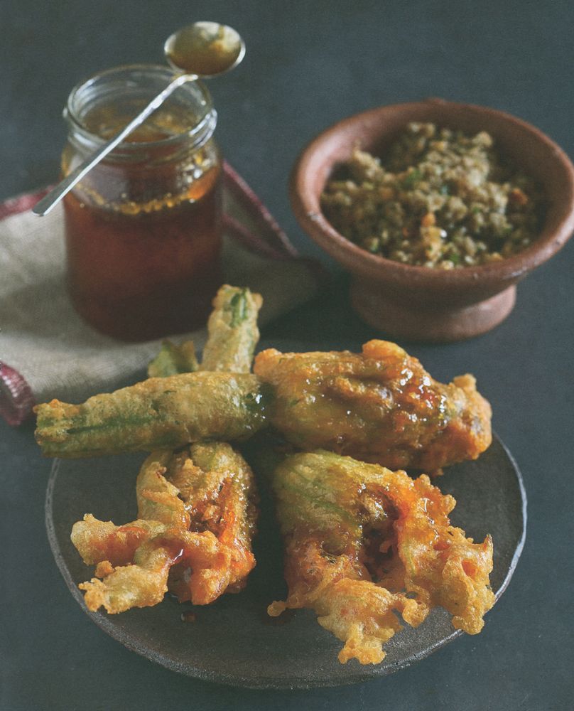 A deepfried courgette flower stuffed with walnuts, garlic & bread