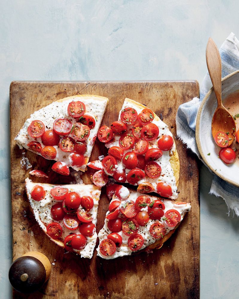 Chickpea flatbread with whipped feta and marinated tomatoes from